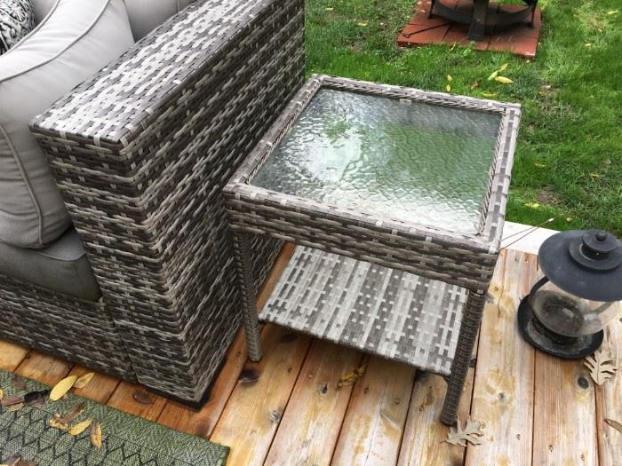 Grey, outdoor wicker sofa and ottoman in beautiful condition, with glass top side table.