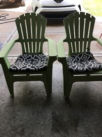 Two green Adirondack chairs.