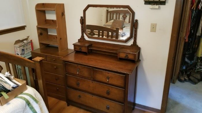 Wooden dresser with mirror. Next to it is a smaller dresser.