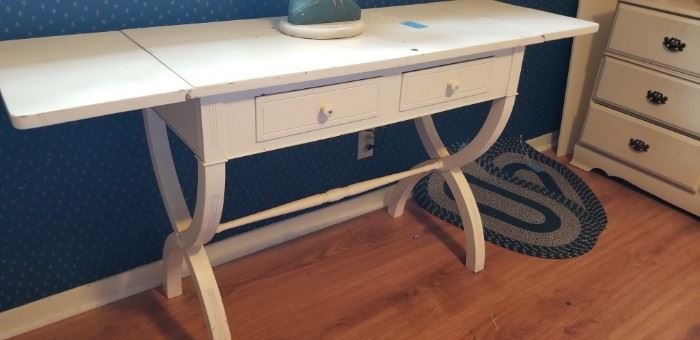white side table with extensions on the ends