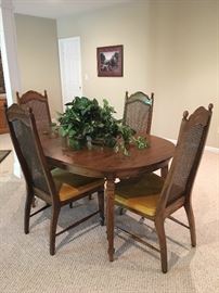 Vintage dining table with 2 leaves and 6 chairs. (one is a Capt. chair)