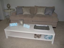 White laminate coffee table, decorative pillows