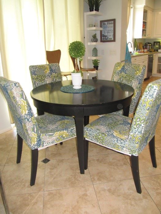 Round dining table with slip covered chairs