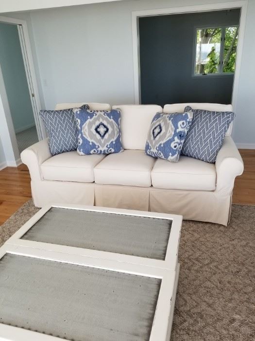 sleeper couch 80Wx39Dx31.5H $2,000.  Off white cotton duck slipcover. Separate cushion seats and backs