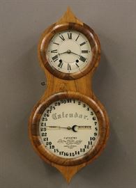 Seth Thomas "Peanut" Calendar Wall Clock - A late 19th century Seth Thomas Office Calendar No. 3 "Peanut" wall clock. 8-day time and strike movement with painted metal dials. Rosewood case with shaped door. Original label and "S T" hands. Old finish with slight wear, nicely restored calendar dial. Running when cataloged. 23 1/4" high overall.