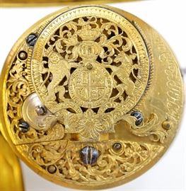 John Hill Verge with Royal Coat of Arms - John Hill ( Son of Benjamin Hill), London, 18th century. This watch has a pierced engraved balance cock with the British Royal Coat of Arms (Post 1702 Unification) and Filigree chain guard with Queen Anne's Royal monogram. 54mm Gilded case with Basket weave design. Fusee verge movement KW (through dial), KS, with Egyptian pillars, marked "Jn Hill, London", having a flat porcelain dial with Roman numerals. Some wear, inset monogram on rear cover, light hairlines and repairs to dial. Winds, sets and running when cataloged.