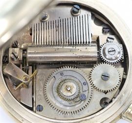 A Swiss pocket watch with incorporated on demand cylinder music box.   SW, PS, 65 mm "Silver" OF, Engraved "Silver" dial with visible balance wheel and  applied numerals. Serial #955.  Some case wear.  Winds, and sets roughly but  runs and plays correctly when cataloged.  
