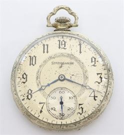 South Bend "Studebaker" Pocket Watch -
South Bend "Studebaker" model 1 pocket watch. 12 size, 21 j, Adj 8 pos, DR, SW, LS, S. W. C. Co. 14k White GF, OF, Silvered SSD w/Arabic numerals. Serial #1195515. Some wear, dial wear. Winds, sets and running when cataloged.