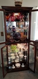 Lighted display cabinet full of vintage glassware. Flow Blue, Fenton,  Hobnail, Crystal and more.
