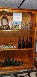 Vintage Glass Door nobs, Brewery Bottles, Insulators and top shelf of this solid pine floor cabinet has heavy craft pieces related to hunting.