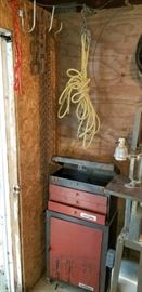 Heavy logging chain hanging, load lock, rope pulley, etc. on wall. Relatively small Rolling Tool-Locker Chest. Better picture coming on the far right floor model band saw.