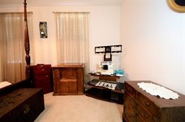 Sewing machine and 3 tiered black modern TV console.