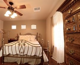 Gold toned metal bed with unusual rounded curved ends. Queen size bed. All bedding for sale all drapes and roods for sale too.