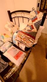 Colorful quilts and new bedding for sale.