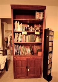 Tall bookcase with bottom storage for sale. CD holder and lots of cds.
