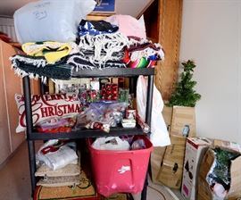 Mexican blankets, sleeping bag, and more Christmas decorations including trees.