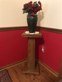 Wooden pedestal with flower arrangement and vase 