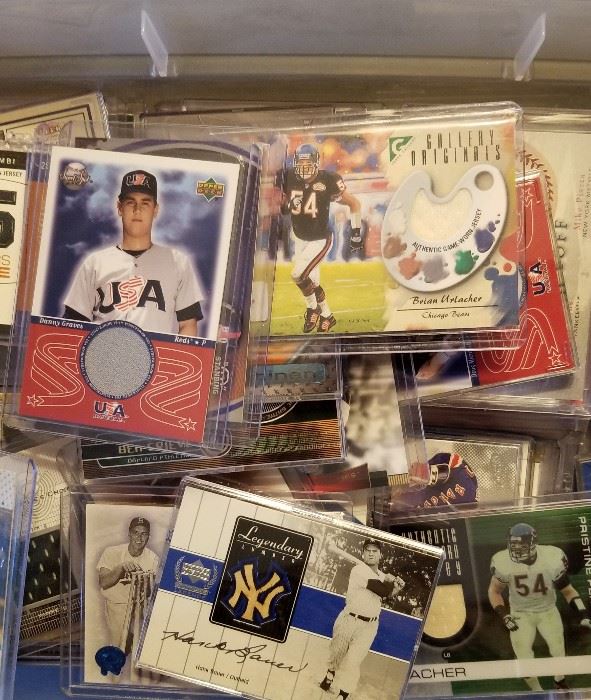 Relic Trading cards, each containing either pieces of a bat or pieces of athletes Uniform.