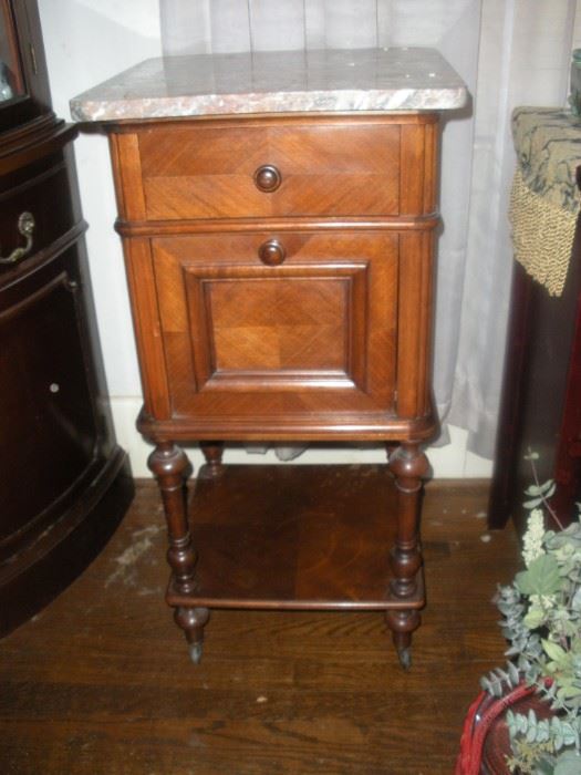 rose marble top commode she used as bedside table