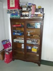 antique storage cabinet with glass doors, puzzles