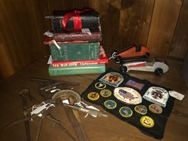 Old tools, vintage pinewood derby cars, Boy Scout patches, interesting books.