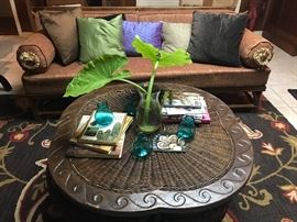 Vintage vogue rattan sofa ( one half of the two - being sold together) lots of great feather filled accent pillows,  7 x 10 Jacobean floral wool rug, great leather accented coffee table with 4 pull out stools.