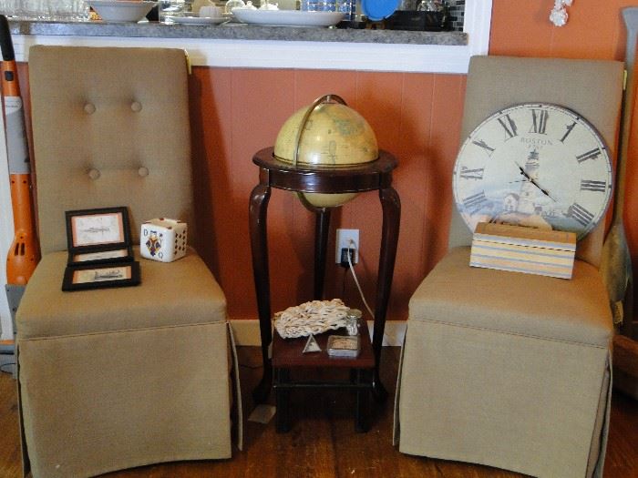 Upholstered chairs and globe
