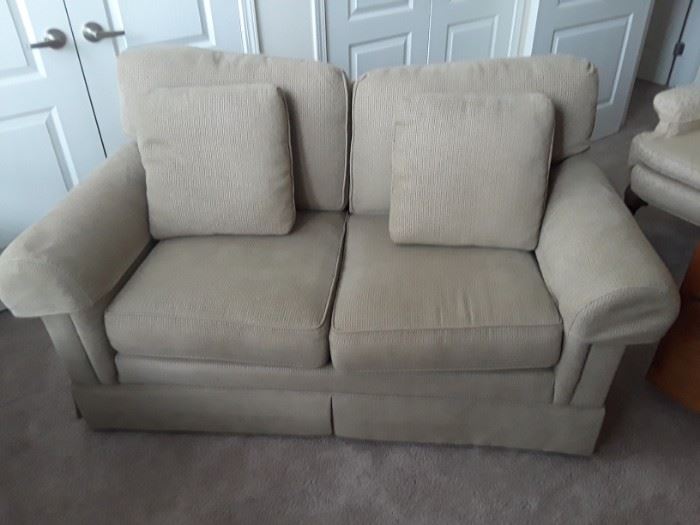 Professionally reupholstered love seat with matching pillows.