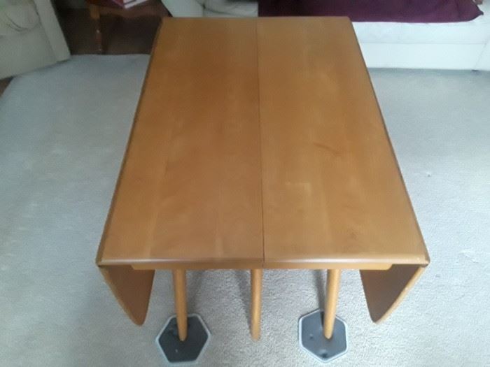 H. W. solid birch table with two leaves and custom pads.  Chairs shown in another picture.