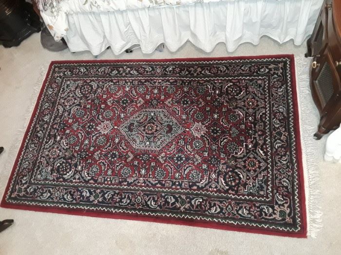 One of 5 asian carpets including one round.
