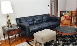 Quality black leather sofa (so soft!!) paired with a black marble top ornate coffee table and an all-sided black marble top side table! Neutral ottoman, black Vesuvio area rug (7.75' x 11'), and a stunning pair of brass Stiffel tabletop lamps!