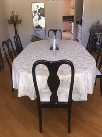 DINING ROOM SET: ANTIQUE EXPANDABLE/ADJUSTABLE PAINTED OVAL OR ROUND TABLE. SOLID/HEAVY/STURDY. 6 - MATCHING BLACK LACQUER CHAIRS: Four leaves turns round table into oval. Table top needs painting. Width: 51”. Length: 95”. Height: 29”.  With no leaves: 52” diameter. 