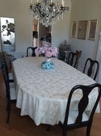 DINING ROOM SET: ANTIQUE EXPANDABLE/ADJUSTABLE PAINTED OVAL OR ROUND TABLE. SOLID/HEAVY/STURDY. 6 - MATCHING BLACK LACQUER CHAIRS: Four leaves turns round table into oval. Table top needs painting. Width: 51”. Length: 95”. Height: 29”.  With no leaves: 52” diameter. 