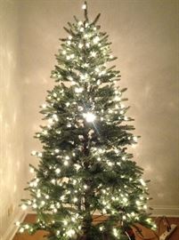 ARTIFICIAL 7 FT. CHRISTMAS TREE W/PRE-STRUNG LIGHTS. 