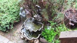 Driveway full of outdoor yard art, fountains, feeders and more.