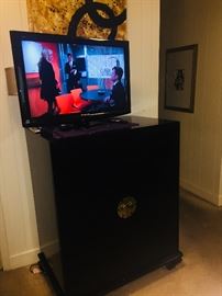 two nice working TVs and a fantastic lacquered cabinet