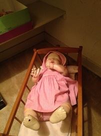 Vintage baby doll in her cradle