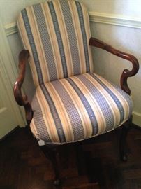 One of two matching blue, yellow, and white arm chairs