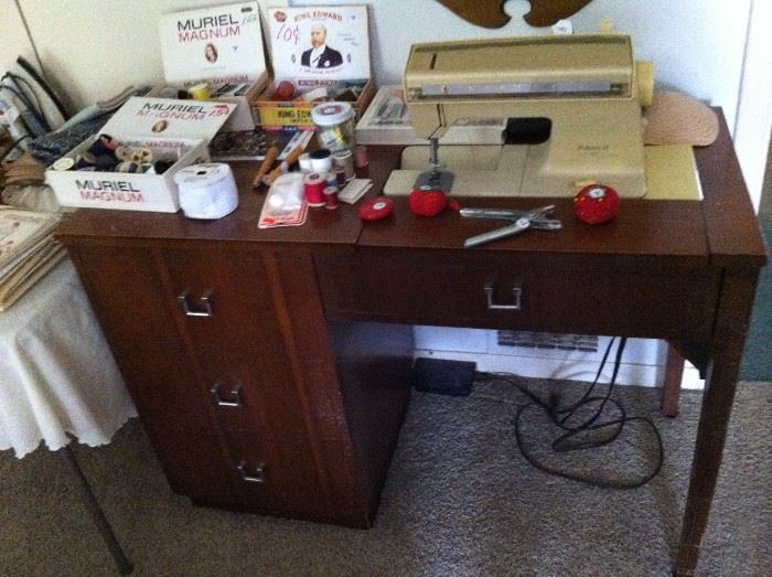Sewing machine in cabinet, sewing supplies