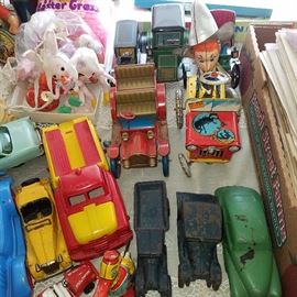 Tin litho friction cars and a wind-up behind the Arcade cast iron and other cars