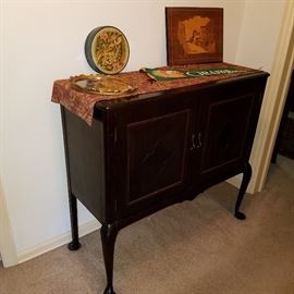 Piano roll cabinet displaying GR pennant, inlaid plaque, etc.