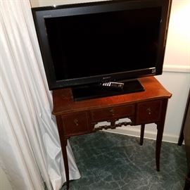 Cute 3-drawer stand displaying Sony flat screen TV