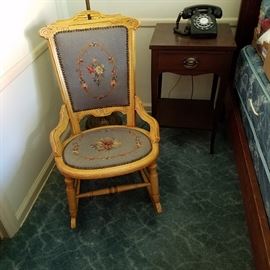 Needlepoint upholstered rocker.  Check out the dial phone!