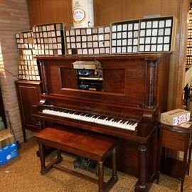 Howard (Baldwin) upright manual pump piano with restored and working player action.  Lots of Ampico rolls.  To left of piano is a roll cabinet