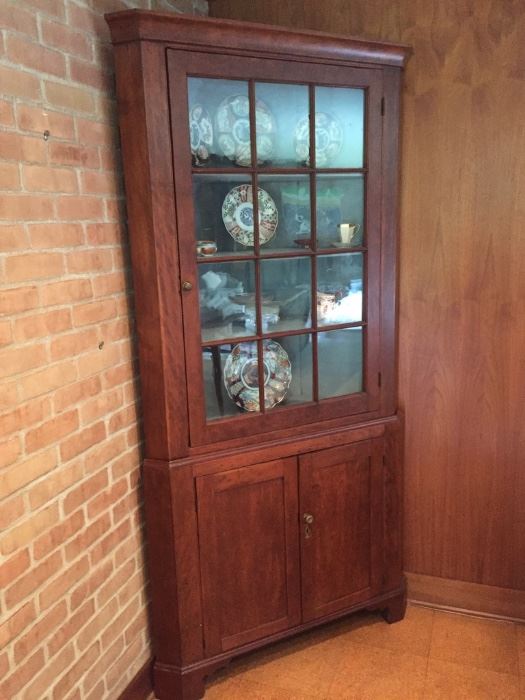 Antique cherry corner cupboard.