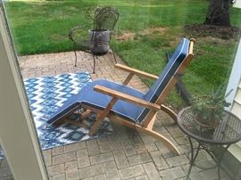 I have two of the teak deck chairs. Really nice and foldable. Rug, small patio table. 
