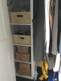 Tall closet shelf with baskets.