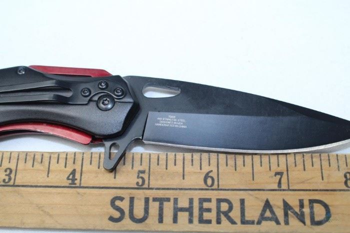 Black Stainless Steel 3.5" Blade Tactical Folding Knife with Red Handle / 440 Stainless Steel Black Coated Blade with Red Contemporary Handle and belt clip. Made in China. Open knife Measures 8'. New in cloth bag
