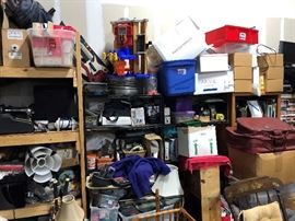 Top shelf has some Oldsmobile hubcaps for garage décor maybe, some Rescue Rangers figurines and toy thing.