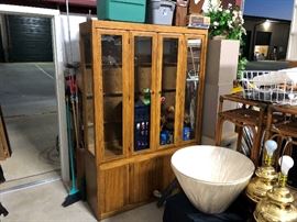 Nice Thomasville China Cabinet, two pieces, no glass for the shelves though, so either make it a wardrobe or you have to get new glass shelves. Couple of lamps and misc things, bunch of brooms and a couple shovels behind
